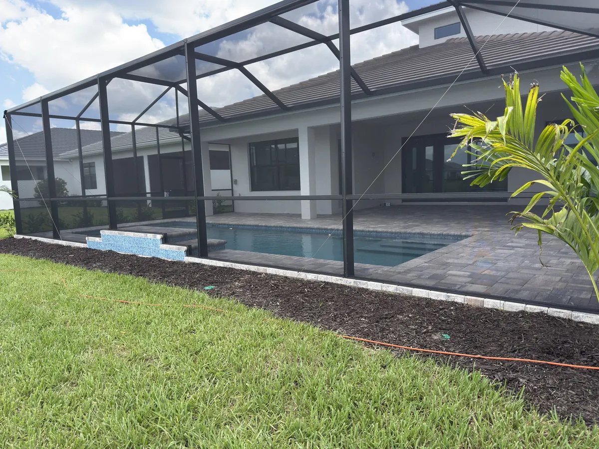 Bronze aluminum pool cage over a paver pool deck, a recent Bradenton area job by 2H Rescreening