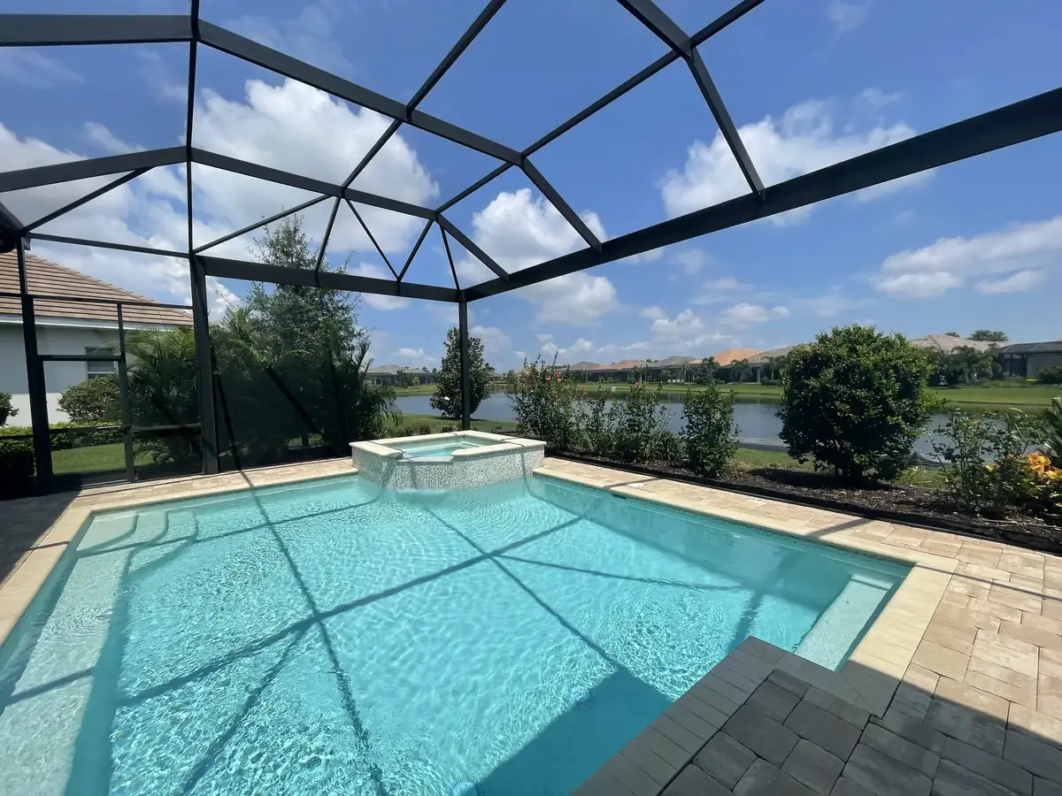 Pool cage over a pool and spa overlooking a lake in Sarasota, Florida