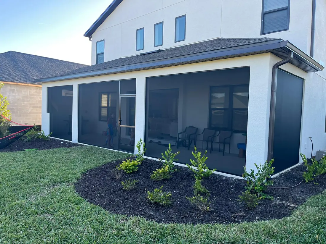 New aluminum lanai screen enclosure attached to the back of a Florida home