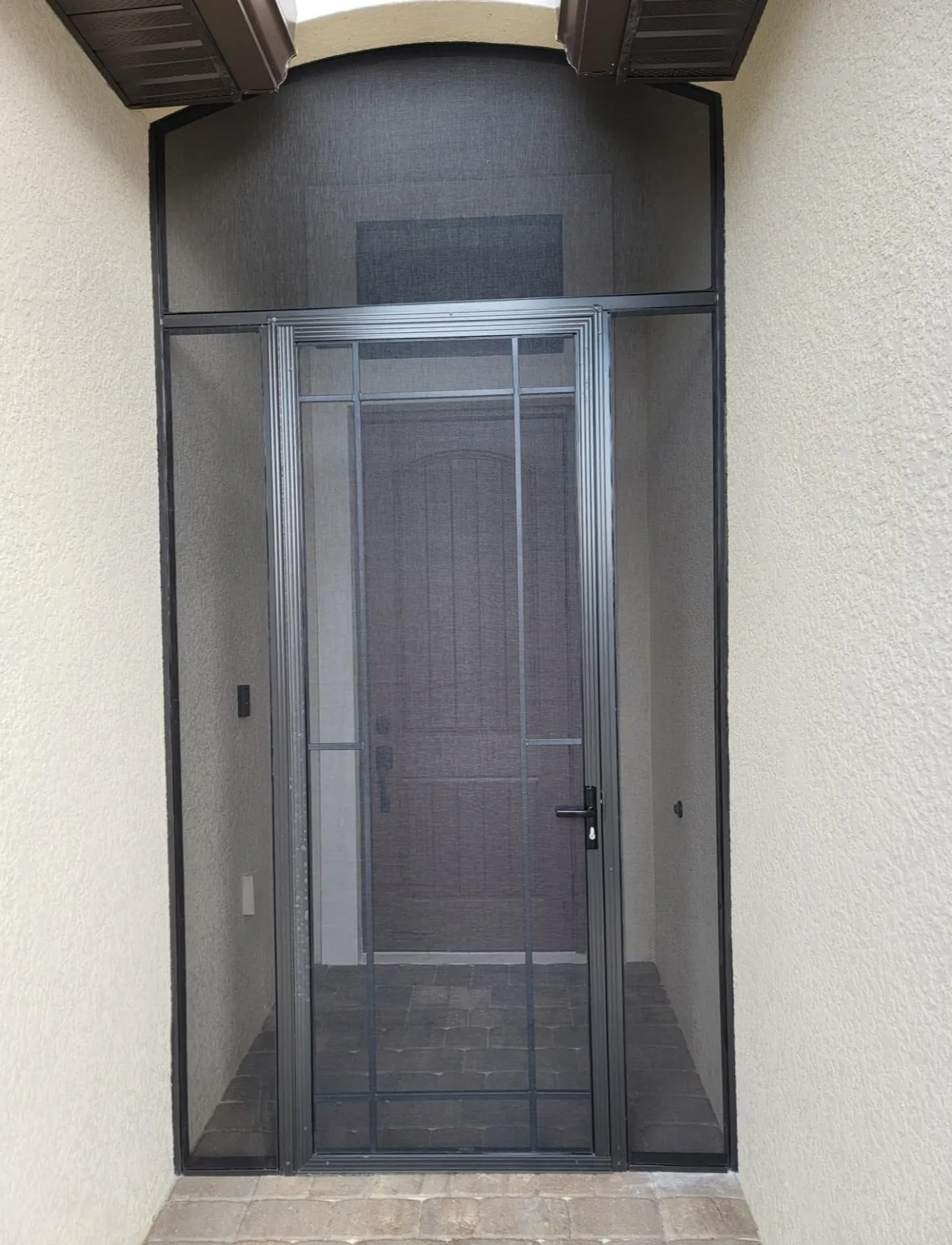 Aluminum screen entry door installed at the front door of a Florida home