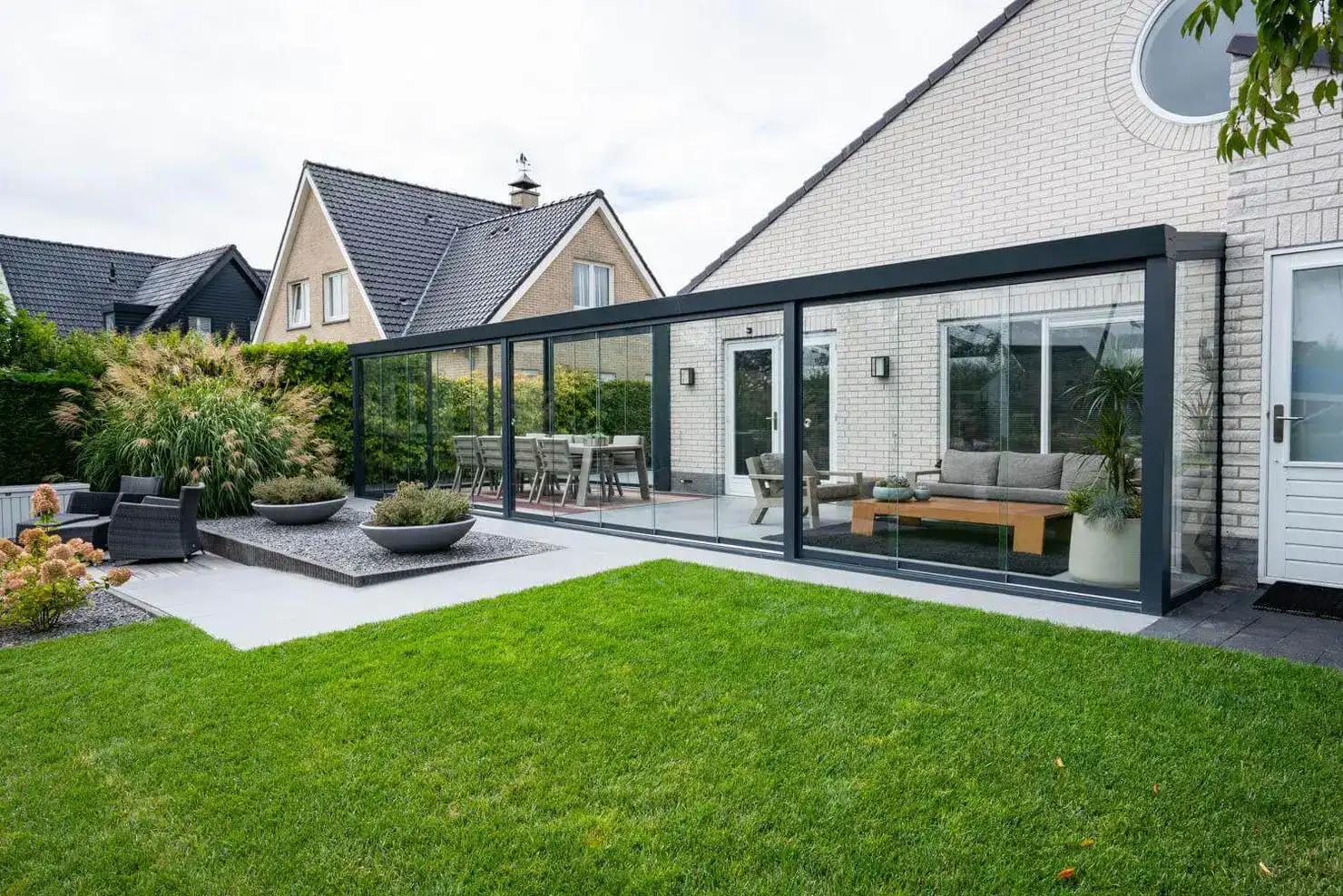 Glass Lanai Enclosure in residential house beside a lawn