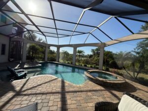 Screened pool area with sealed pavers in a Sarasota backyard