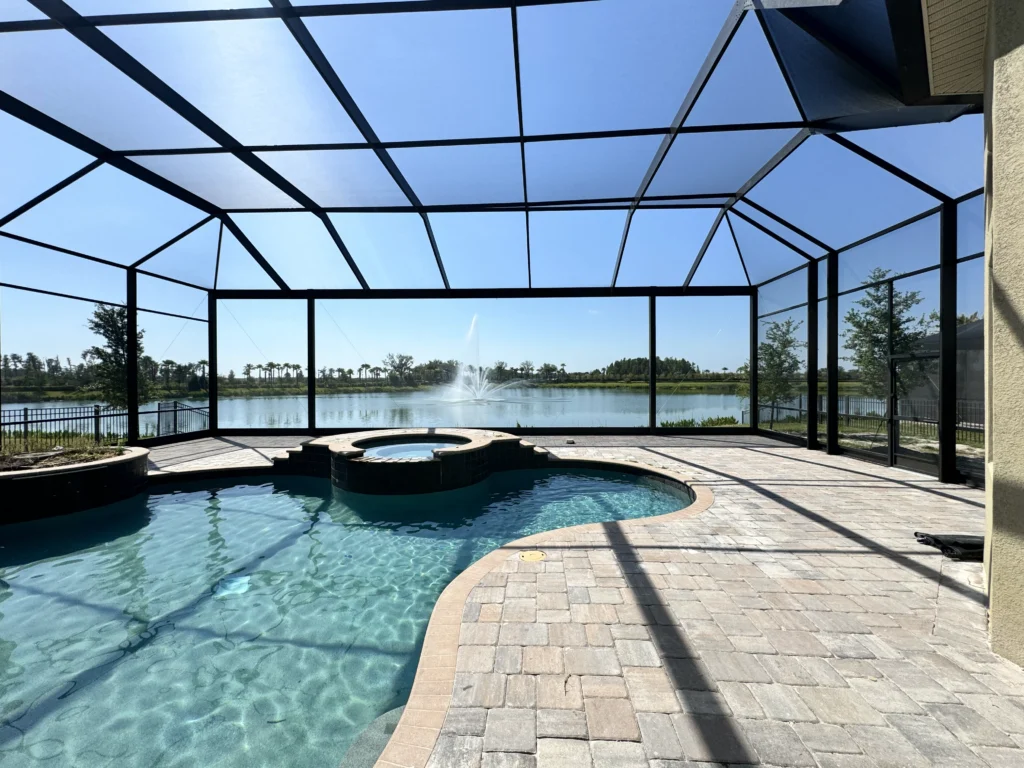 Pool cage with newly installed pavers in Sarasota by 2H Rescreening
